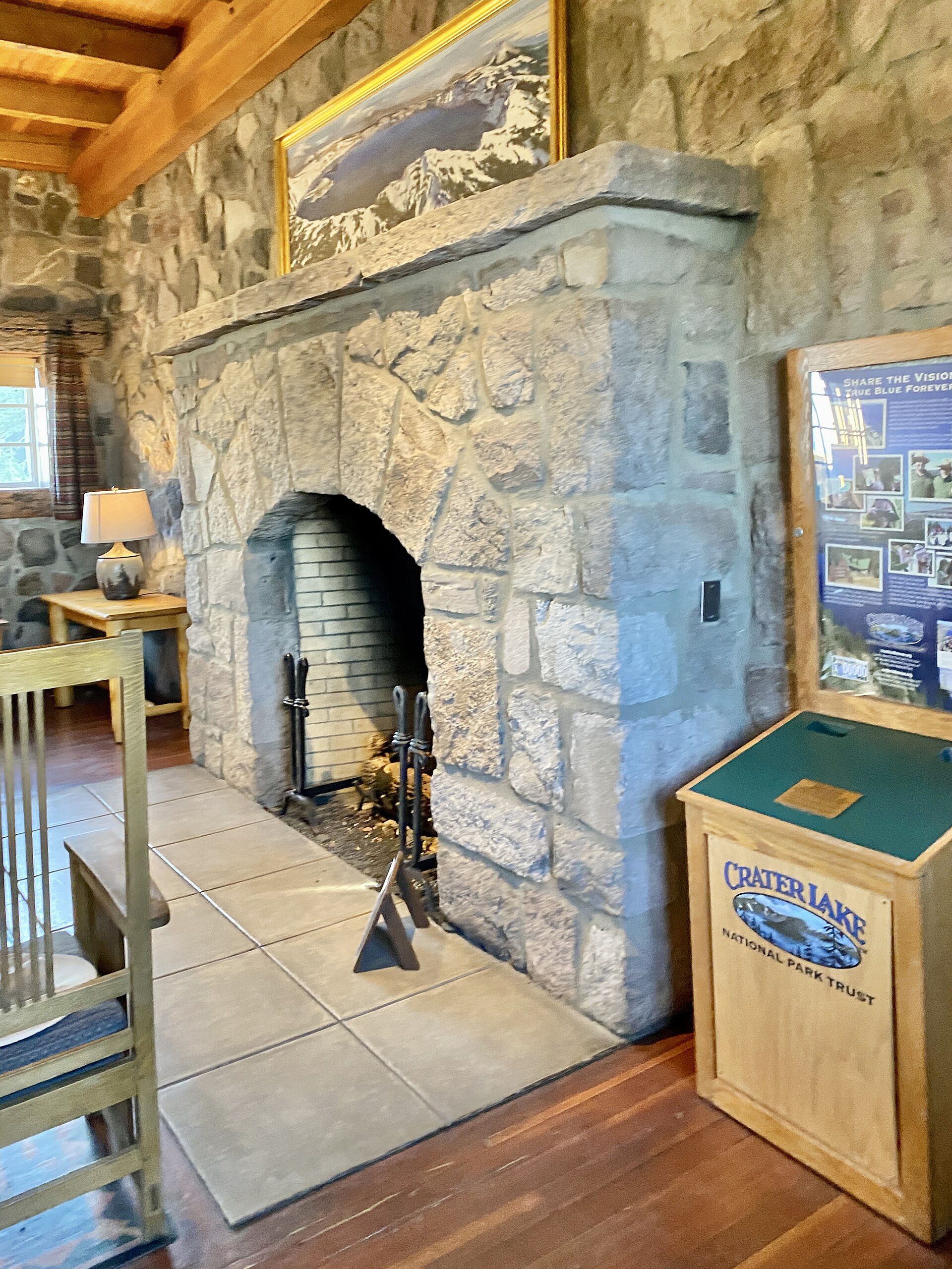 A large stone fireplace in a timber lodge