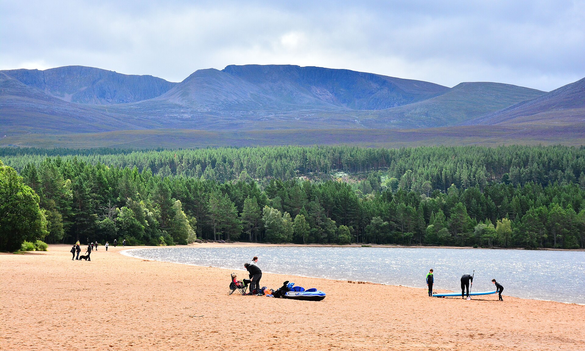A still loch with Cairngorm mountain behind